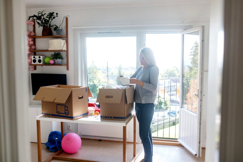 Female student unpacking in new residence