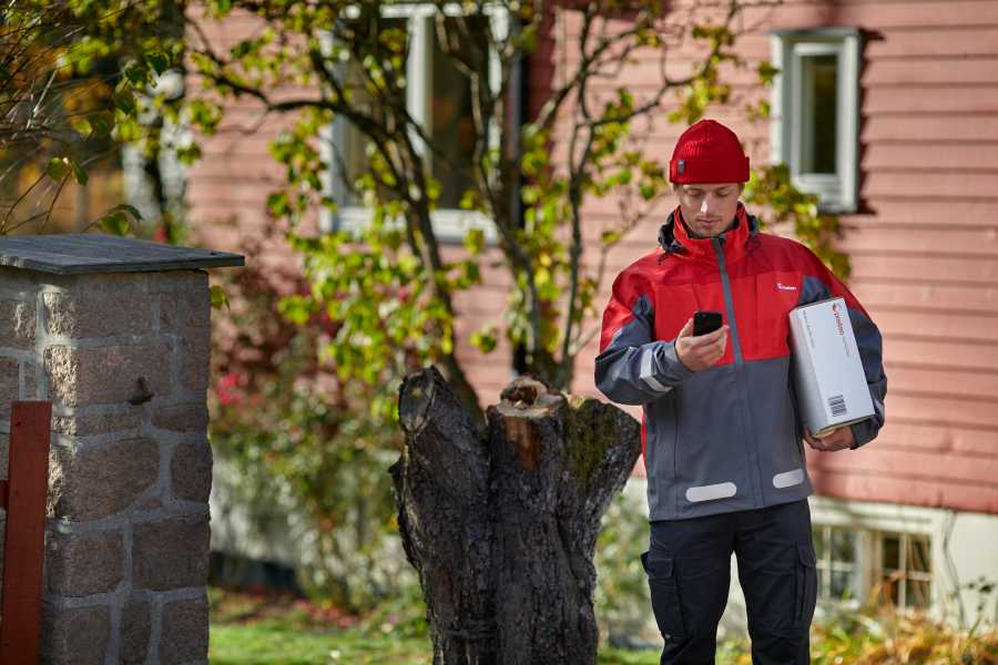 Mailman with a parcel and a phone in his hand.