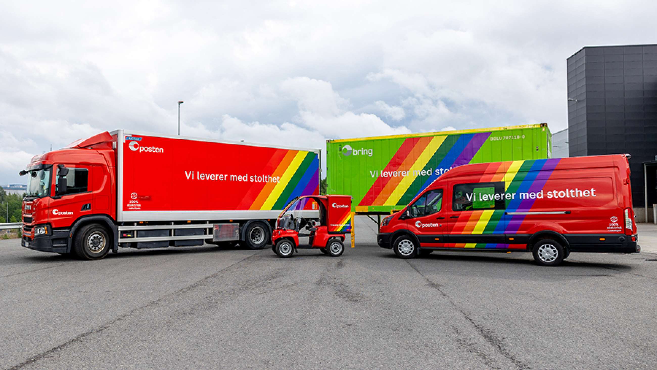 Lastebiler, Paxster og varebil fra Posten Bring, dekorert med regnbuefarger og teksten "Vi leverer med stolthet"